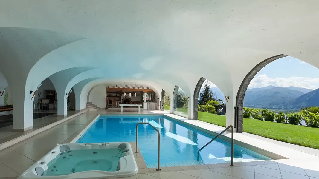 Indoor Swimming Pool with Hot Tubs built inside a luxury home wellness area